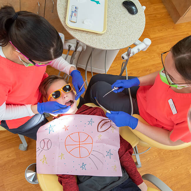 A child lying in a dental chair during a procedure 